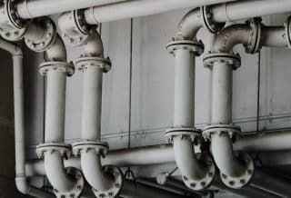 grayscale photography of metal pipes