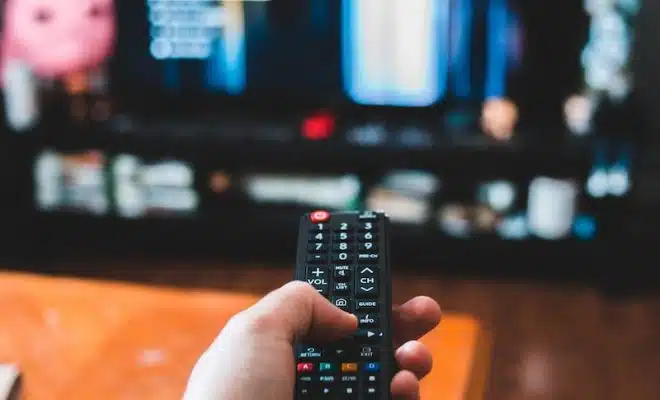 person holding black remote control